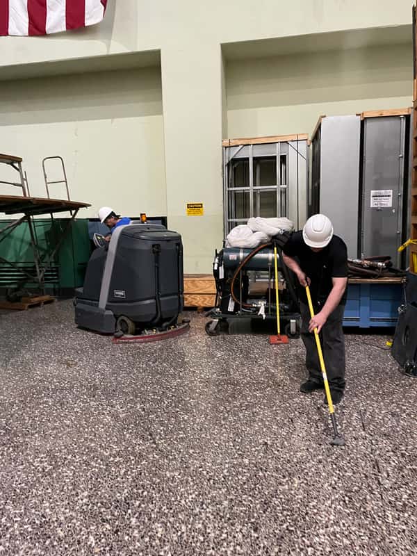 JSD technician mopping around facility equipment