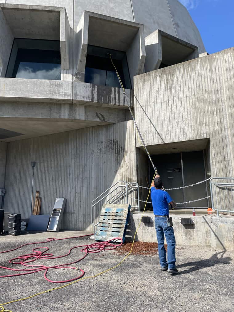 JSD Cleaning Services team member cleaning exterior windows